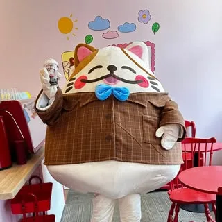 Our Jancat mascot in the café, bubble tea in paw